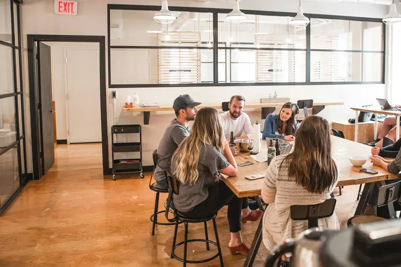 A team around a long table in a bright office