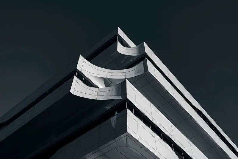 A modern building with white lines against a dark sky
