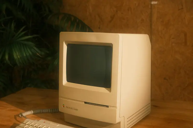 An old Macintosh on a wooden table