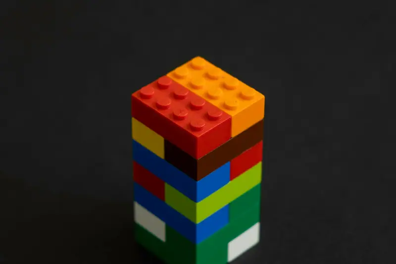 A tower of Lego bricks against a black background
