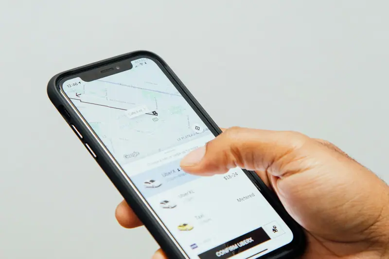 A hand using an app on a smartphone