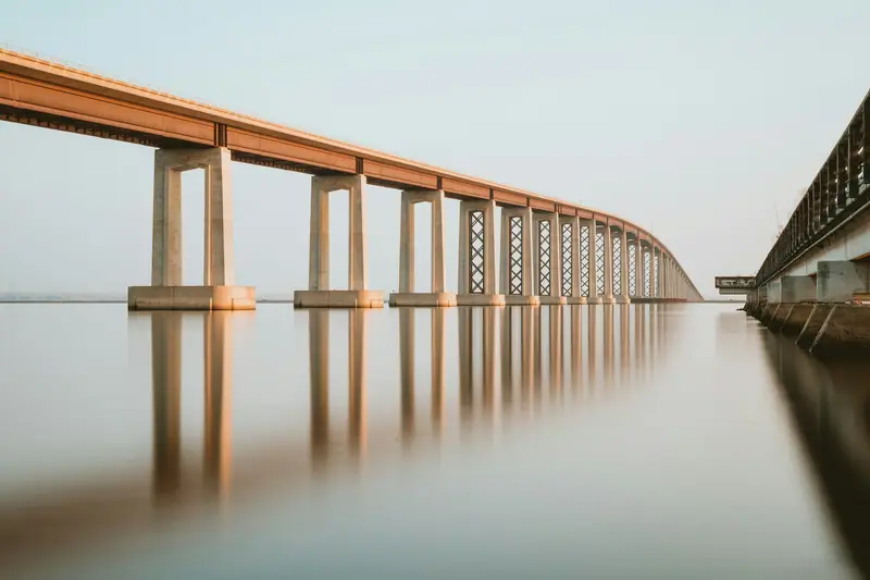 A long bridge on pillars reflected in the water